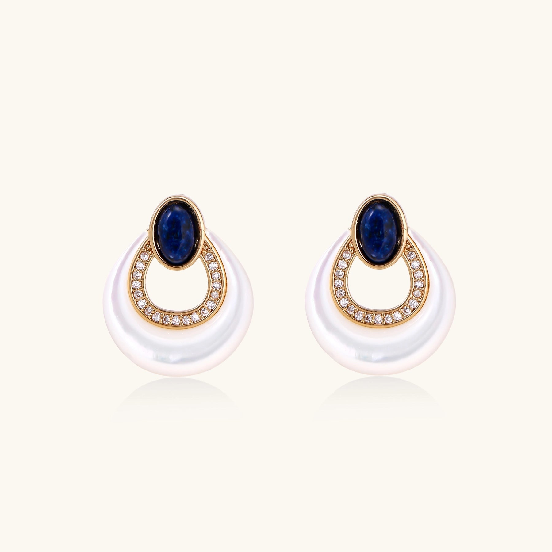 Gold-plated drop earrings featuring blue lapis lazuli ovals, diamond-studded circles, and iridescent mother of pearl teardrops