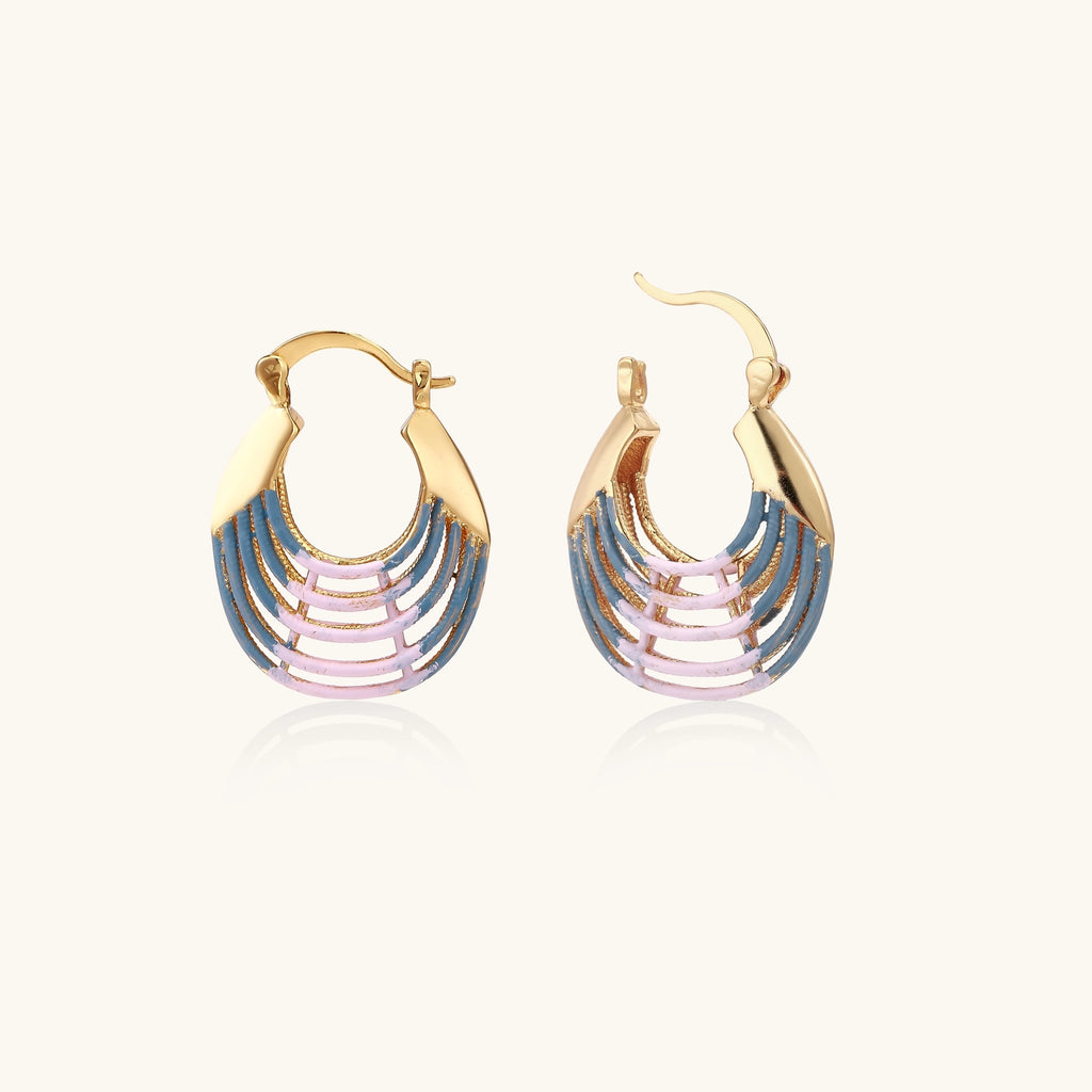 Gold hoop earrings with layered blue to pink enamel in shell pattern, photographed against white background