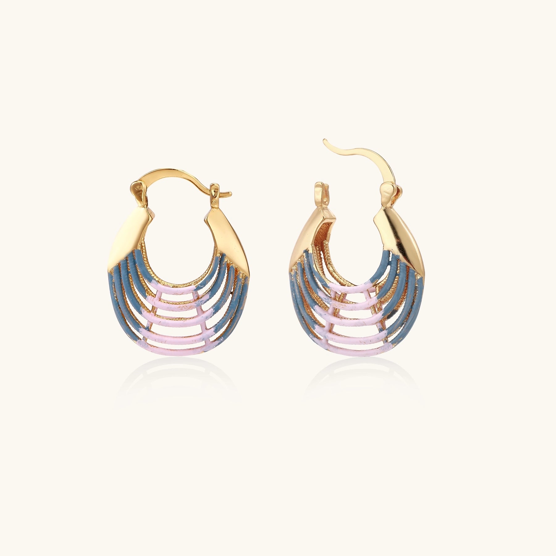 Gold hoop earrings with layered blue to pink enamel in shell pattern, photographed against white background