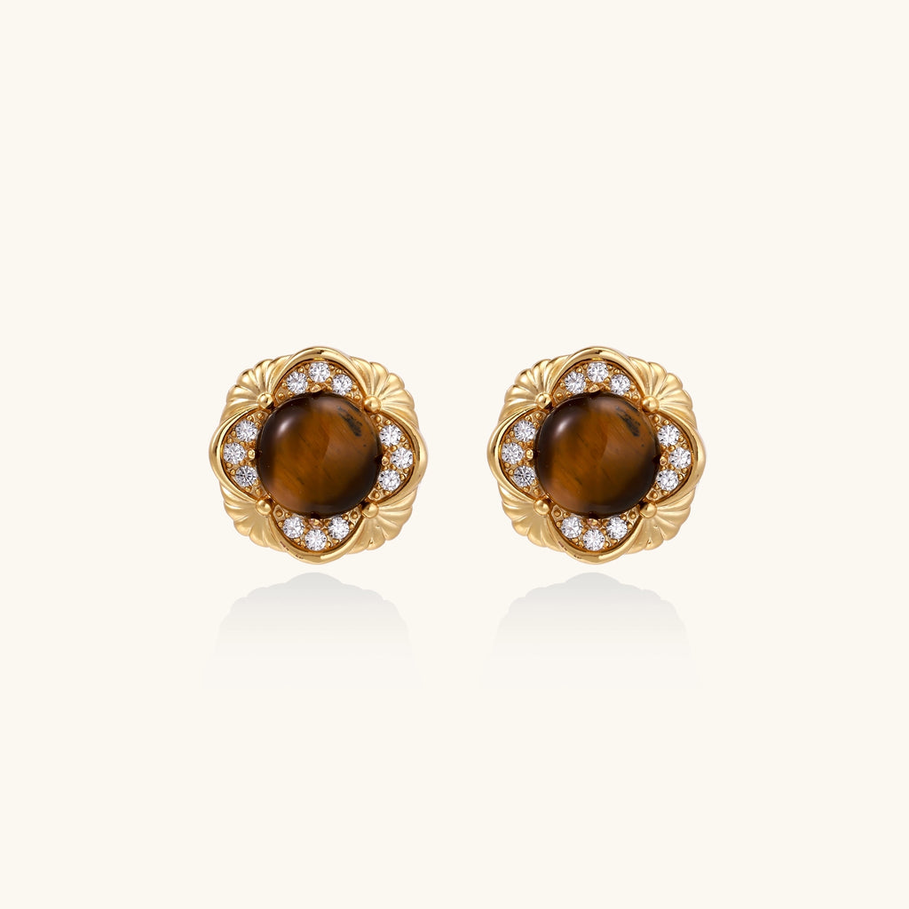 Ornate gold-plated brass stud earrings featuring round tiger's eye stones surrounded by sparkling zirconia in floral design